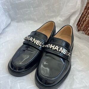 CHANEL Shiny Black Loafers with Silver Logo